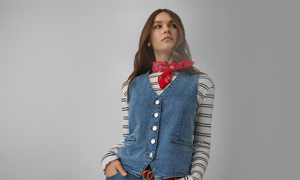 A nő kék farmermellényt és piros kendőt visel a nyakán.